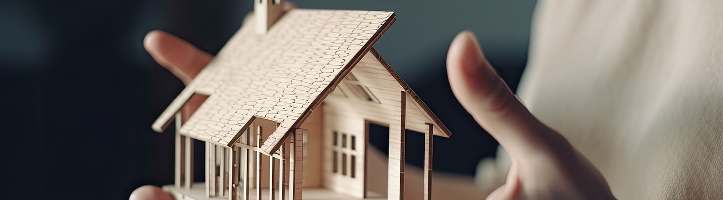 person-holds-small-wooden-house-.jpg