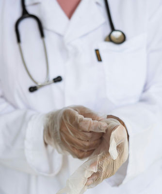 Doctor putting on the gloves for examination