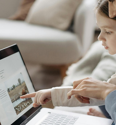 A tutor teaching the student on the laptop