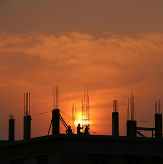 People working at the construstion site until sunset